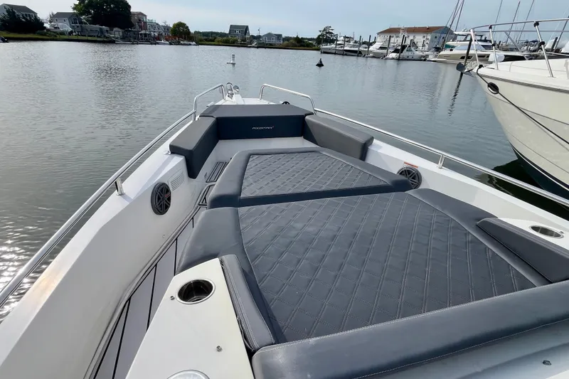 Slide: The Image of 2018 Axopar 37 Sport Cabin R with spacious deck and luxurious seating in marina. - 10