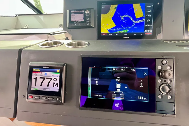 Slide: The Image of Dashboard of 2018 Axopar 37 Sport Cabin R with Garmin navigation displays. - 12