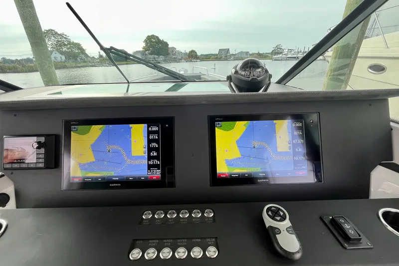Slide: The Image of Axopar 37 Sport Cabin R 2018 dashboard with navigation screens and controls. - 13