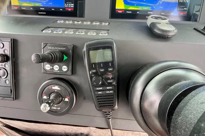 Slide: The Image of Control panel of a 2018 Axopar 37 Sport Cabin R with navigation and communication devices. - 14