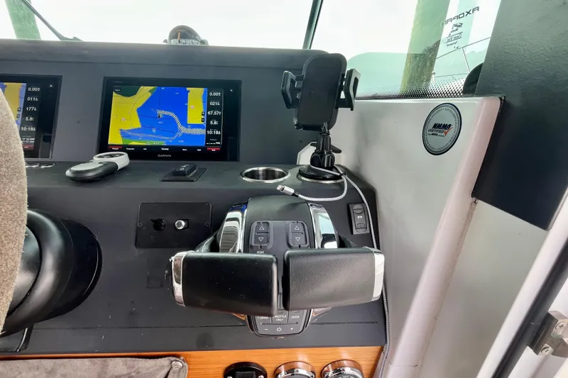 Slide: The Image of Control panel of 2018 Axopar 37 Sport Cabin R with navigation display and controls. - 15