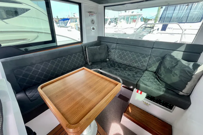 Slide: The Image of Luxurious interior of 2018 Axopar 37 Sport Cabin R with elegant seating and wooden table. - 17