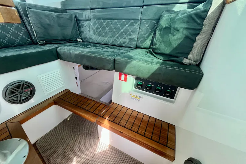 Slide: The Image of Interior of 2018 Axopar 37 Sport Cabin R with cushioned seating and control panel. - 19