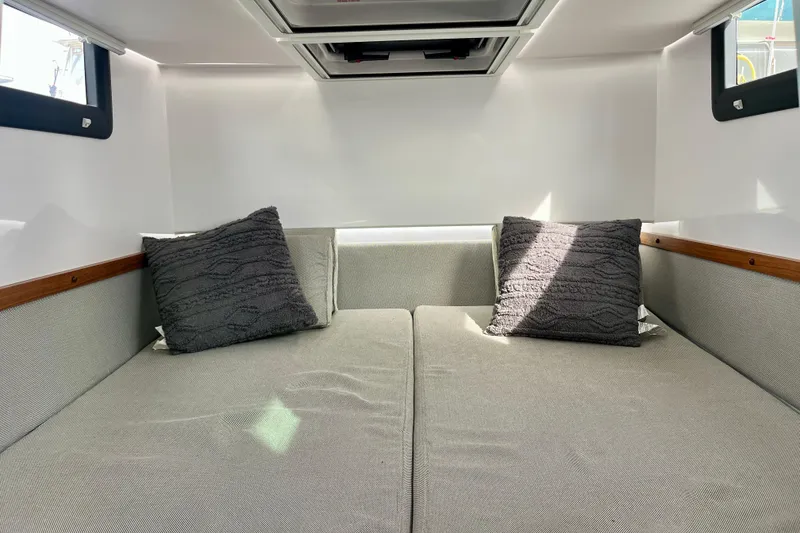 Slide: The Image of Interior cabin of 2018 Axopar 37 Sport Cabin R with gray cushions and pillows. - 24