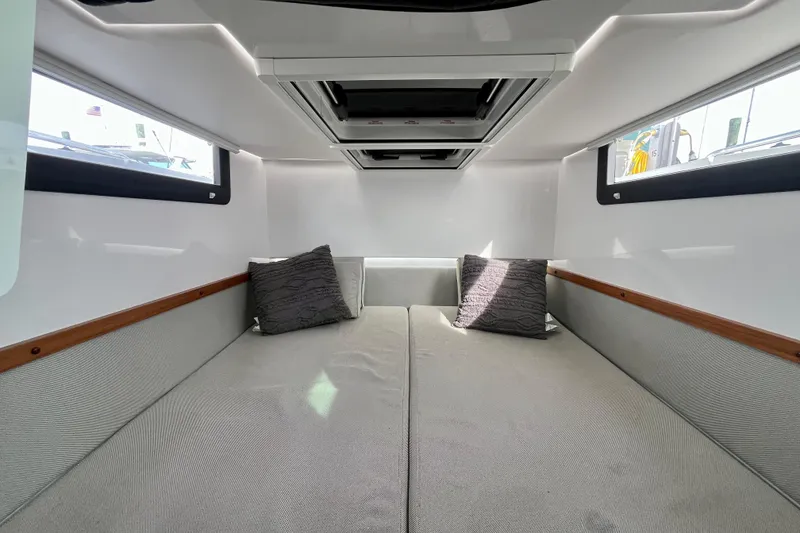 Slide: The Image of 2018 Axopar 37 Sport Cabin R interior with cozy bed and pillows. - 25