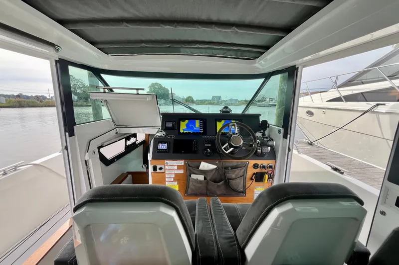 Slide: The Image of Interior view of 2018 Axopar 37 Sport Cabin R, featuring modern helm and navigation equipment. - 26