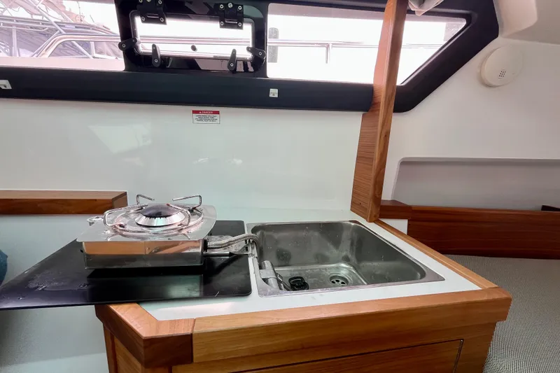 Slide: The Image of 2018 Axopar 37 Sport Cabin R interior with compact kitchen sink and stove. - 29