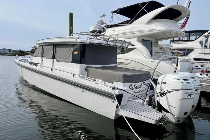 Slide: The Image of 2018 Axopar 37 Sport Cabin R docked, featuring twin 400R engines, sleek design. - 3