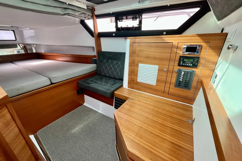 Slide: The Image of Interior of 2018 Axopar 37 Sport Cabin R, featuring wood paneling and seating. - 30