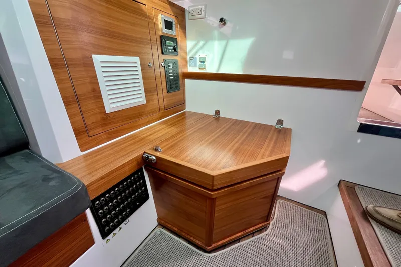 Slide: The Image of 2018 Axopar 37 Sport Cabin R interior with wood paneling and control panels. - 31