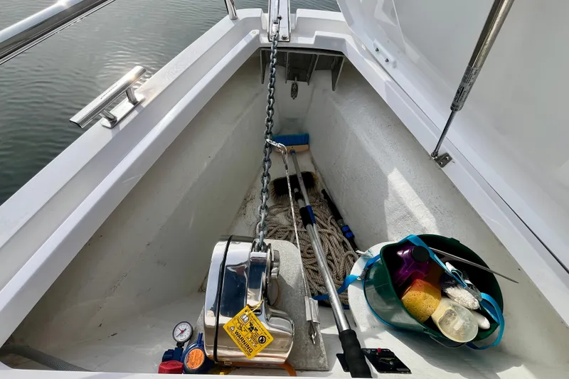 Slide: The Image of Storage compartment of 2018 Axopar 37 Sport Cabin R with cleaning supplies and anchor chain. - 39