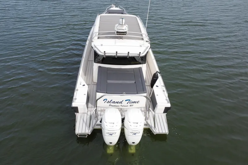 Slide: The Image of 2018 Axopar 37 Sport Cabin R on water, rear view with twin engines. - 4