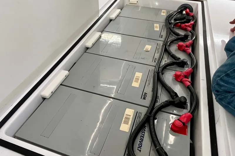 Slide: The Image of Battery compartment of 2018 Axopar 37 Sport Cabin R with AGM batteries and cables. - 40