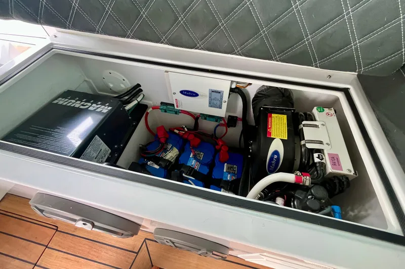 Slide: The Image of Electrical components inside 2018 Axopar 37 Sport Cabin R boat, featuring batteries and wiring. - 41