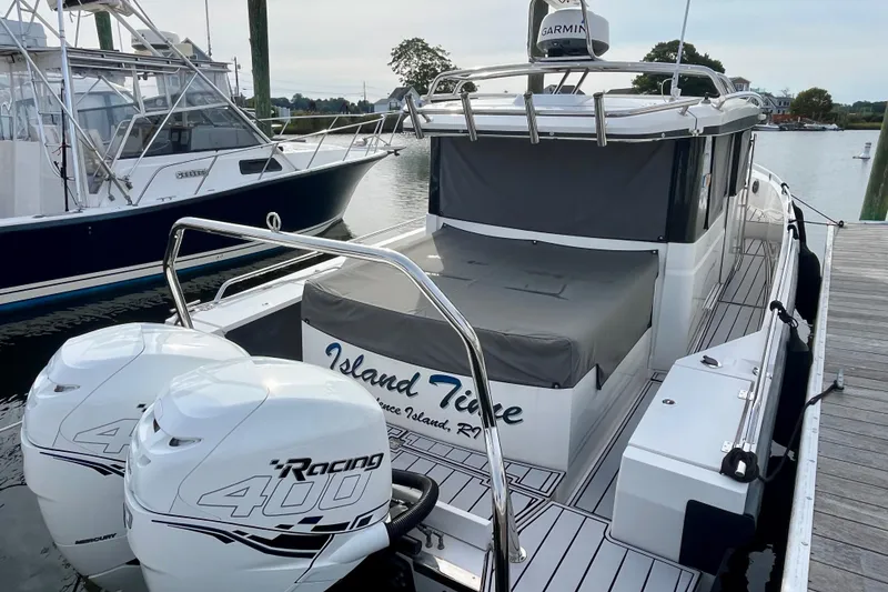 Slide: The Image of 2018 Axopar 37 Sport Cabin R docked, featuring twin Mercury Racing 400 engines. - 42