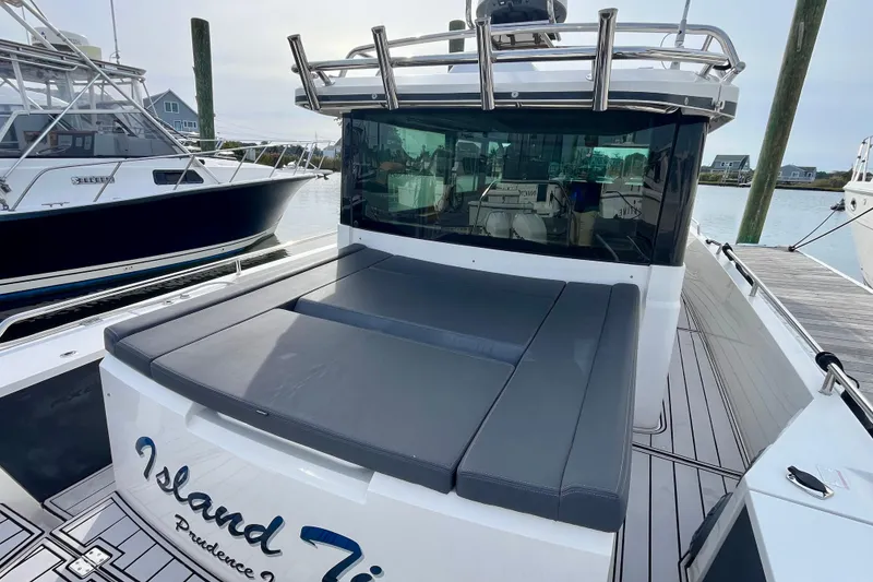 Slide: The Image of 2018 Axopar 37 Sport Cabin R docked, featuring sleek design and spacious seating area. - 5