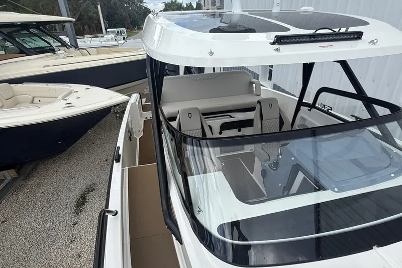 Slide: The Image of 2026 Navan S30 boat with sleek design and modern interior, docked outdoors. - 17