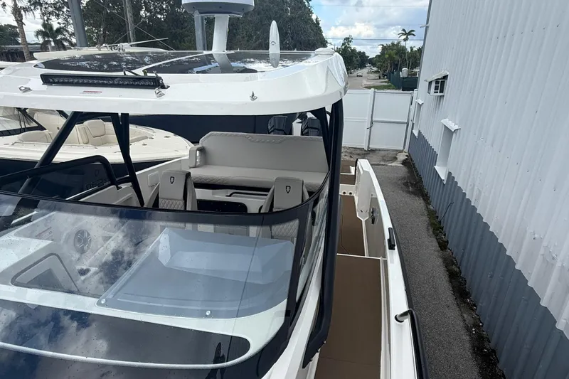 Slide: The Image of 2026 Navan S30 boat with sleek design and modern features, docked near a building. - 18