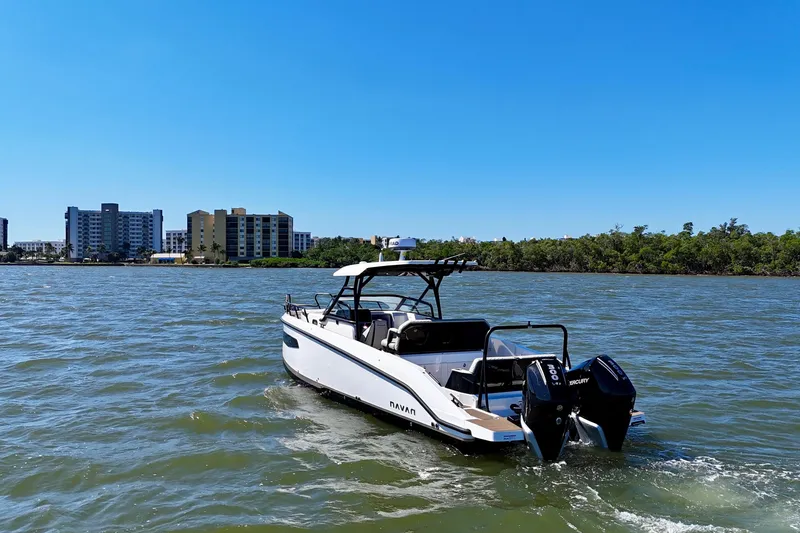 Slide: The Image of Navan S30 boat 2026 on open water with cityscape backdrop. - 3