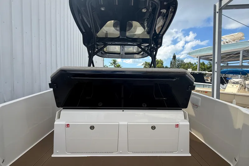 Slide: The Image of 2026 Navan S30 boat interior with storage compartments and canopy, docked outdoors. - 8