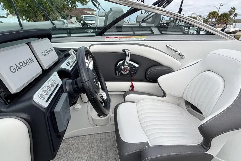 Slide: The Image of Interior of 2026 Crownline 260 XSS boat with Garmin navigation system and plush seating. - 11
