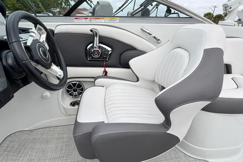 Slide: The Image of 2026 Crownline 260 XSS boat interior with sleek steering wheel and modern seating design. - 12