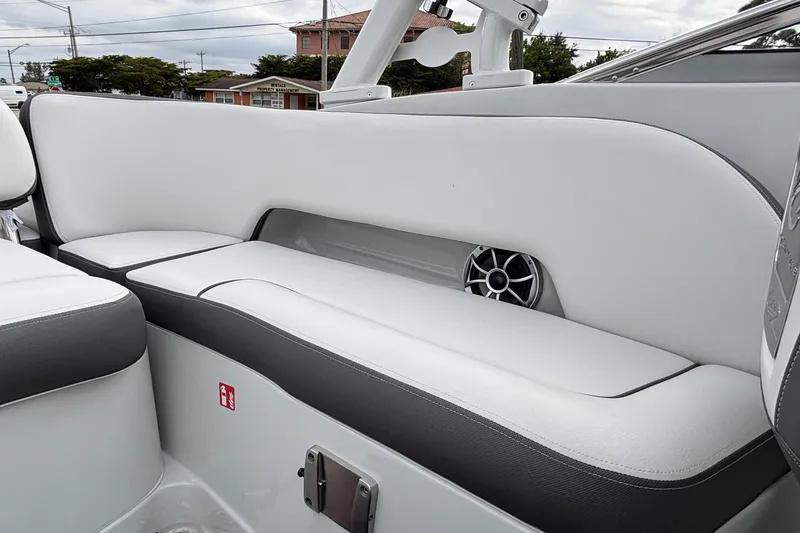 Slide: The Image of 2026 Crownline 260 XSS boat interior with white seating and built-in speaker. - 13