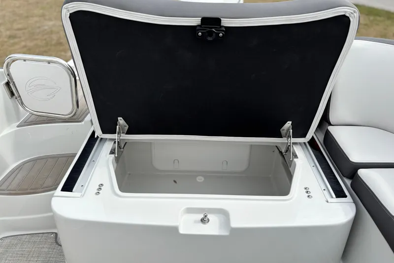 Slide: The Image of Open storage compartment on 2026 Crownline 260 XSS boat, showcasing interior space. - 17