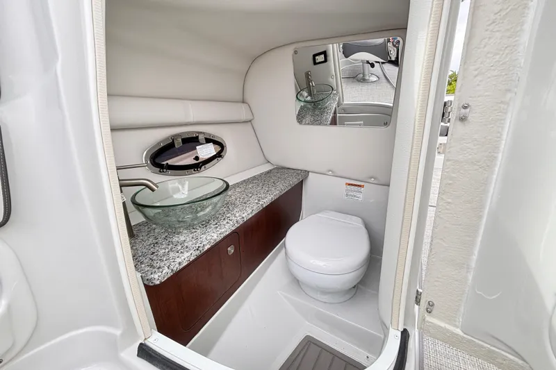 Slide: The Image of Luxurious bathroom in 2026 Crownline 260 XSS boat with modern fixtures and granite countertop. - 20