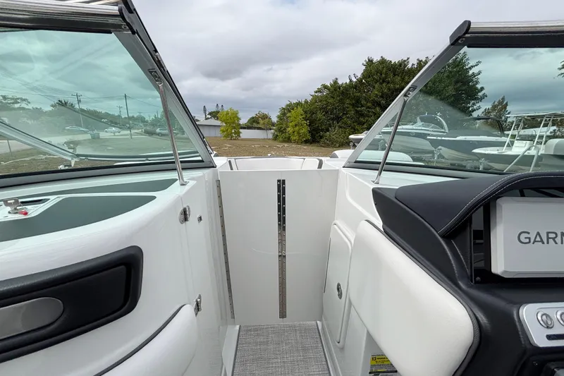 Slide: The Image of 2026 Crownline 260 XSS boat interior with windshield and dashboard view. - 21
