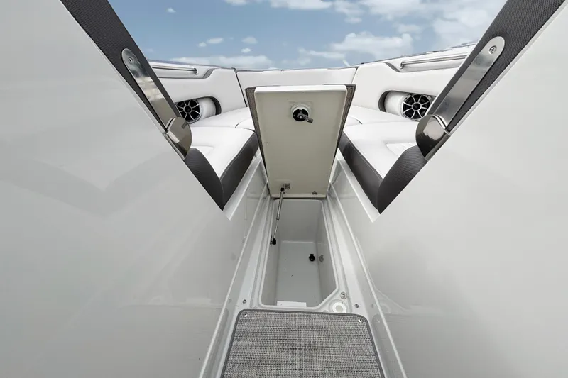 Slide: The Image of 2026 Crownline 260 XSS boat interior storage compartment with open hatch. - 24