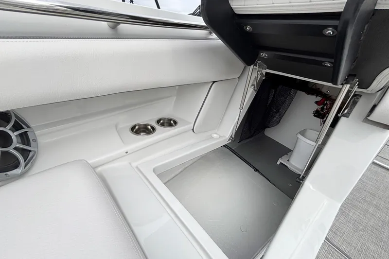 Slide: The Image of 2026 Crownline 260 XSS boat interior with storage and cup holders. - 28