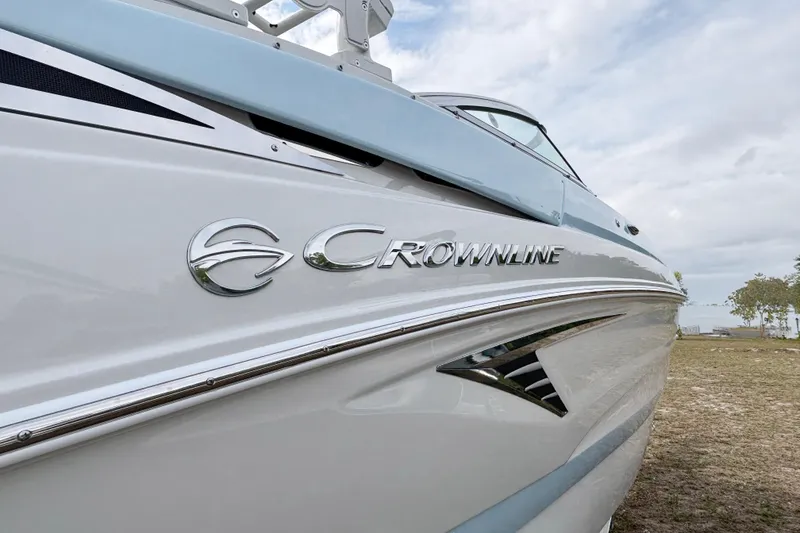 Slide: The Image of 2026 Crownline 260 XSS boat side view with logo, sleek design, and chrome accents. - 34
