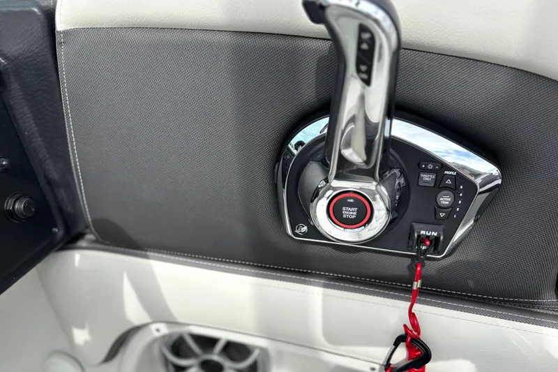 Slide: The Image of Control panel of 2026 Crownline 260 XSS boat with start-stop button and throttle lever. - 7