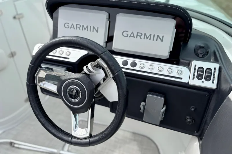 Slide: The Image of 2026 Crownline 260 XSS boat dashboard with Garmin navigation system and steering wheel. - 8