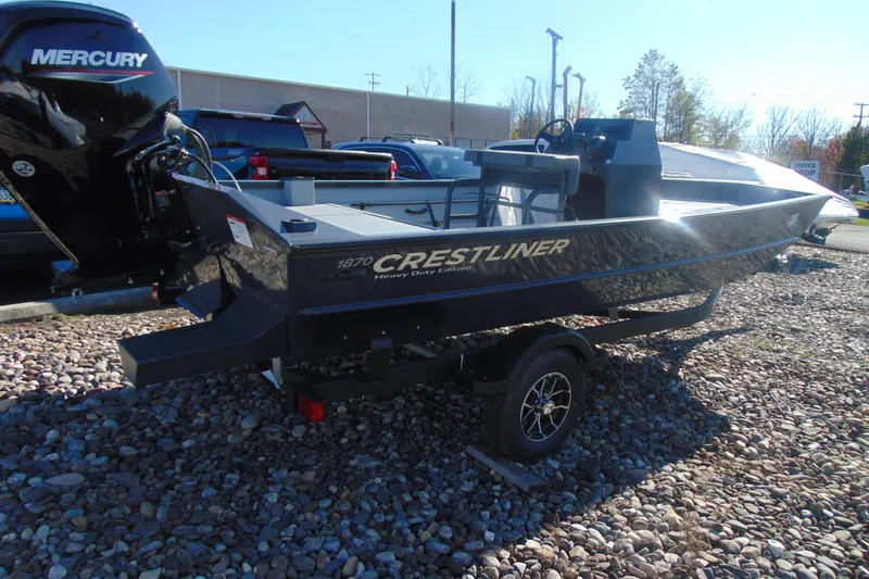 Slide: The Image of 2026 Crestliner 1870 Retriever FCC boat with Mercury engine on rocky terrain. - 5