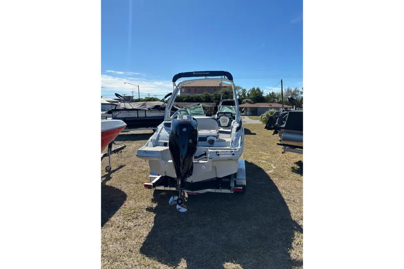 Slide: The Image of 2026 Crownline Eclipse E240 XS boat, rear view, parked outdoors on grass. - 10