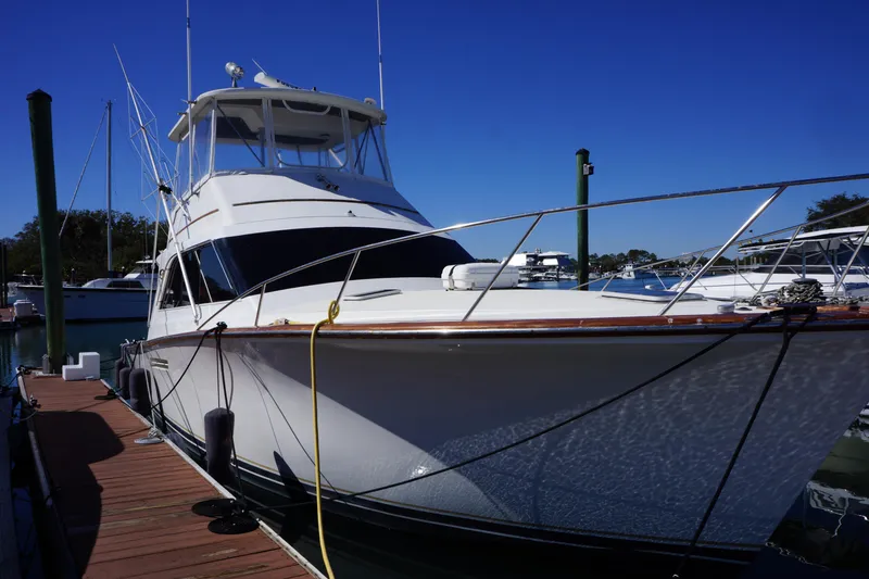 Slide: The Image of 1988 Ocean Yachts Super Sport docked at marina under clear blue sky. - 0