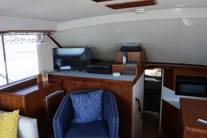 Slide: The Image of Interior of 1988 Ocean Yachts Super Sport with TV, seating, and wooden cabinetry. - 21