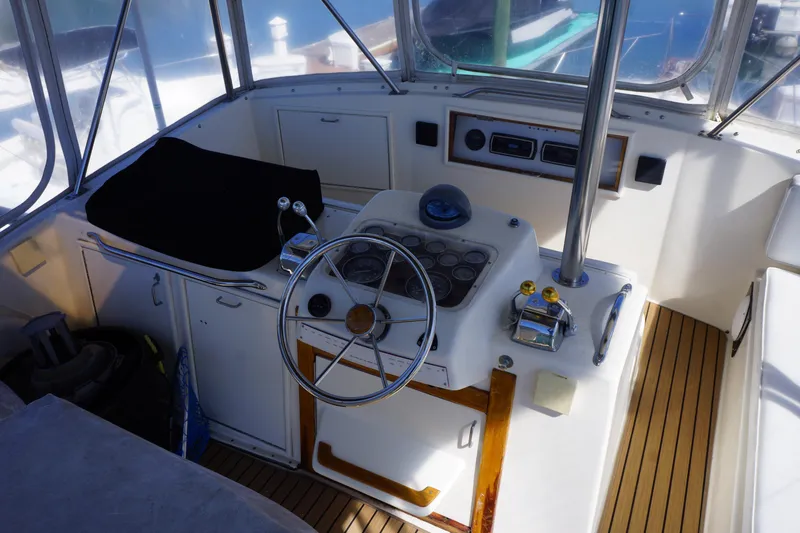 Slide: The Image of 1988 Ocean Yachts Super Sport helm with steering wheel and control panel. - 23