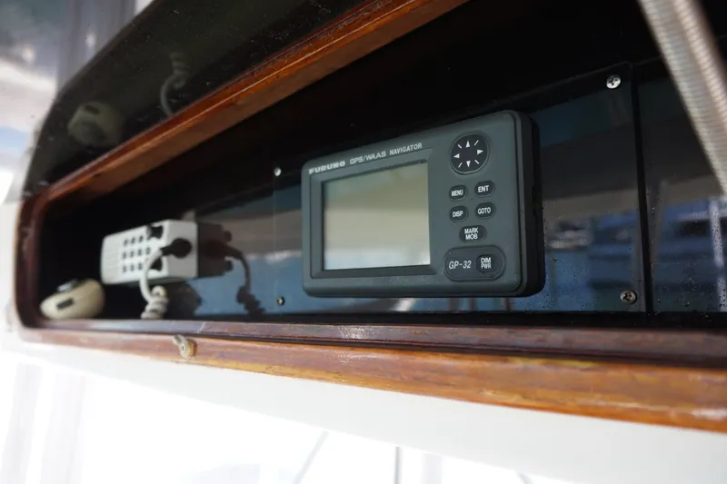 Slide: The Image of 1988 Ocean Yachts Super Sport navigation equipment with GPS display and control panel. - 27