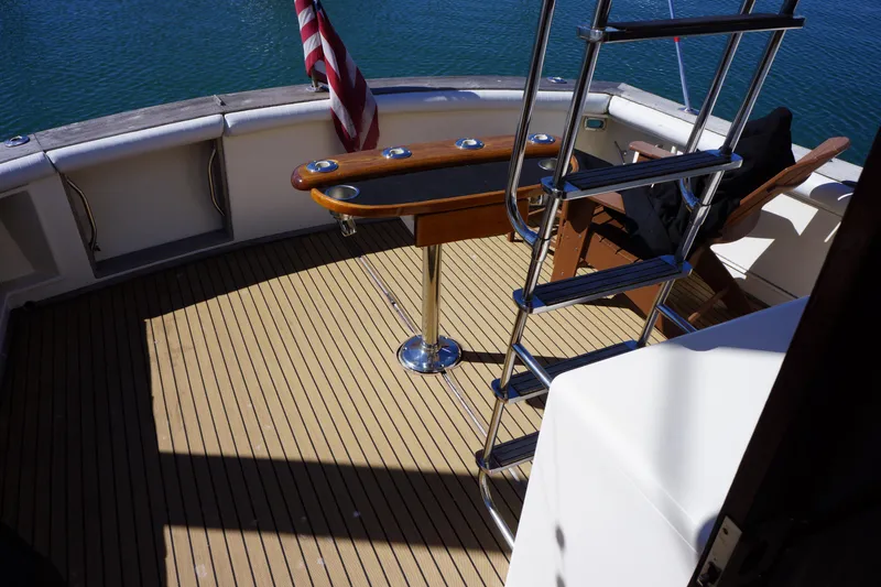 Slide: The Image of 1988 Ocean Yachts Super Sport deck with ladder and American flag. - 9
