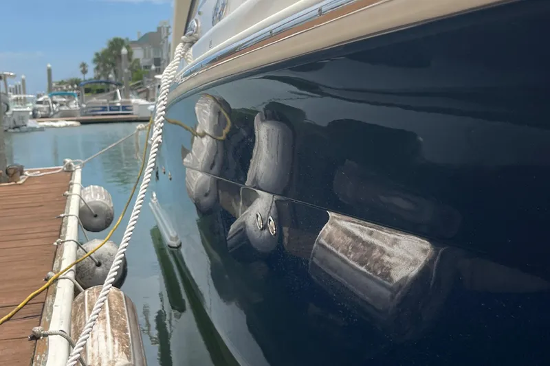 Slide: The Image of 2015 Scout 275 Dorado boat docked in a marina, clear blue sky. - 11