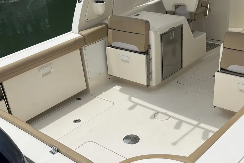 Slide: The Image of Interior view of 2015 Scout 275 Dorado boat, featuring helm and seating area. - 13