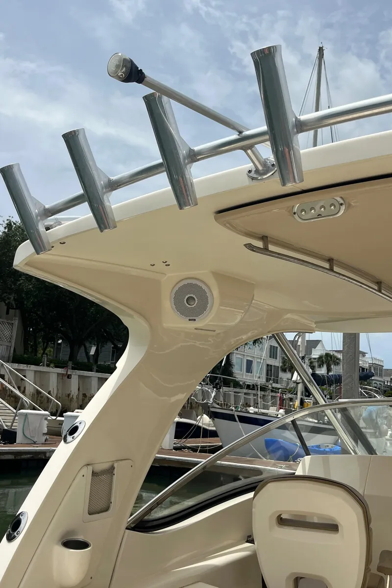 Slide: The Image of Compass on 2015 Scout 275 Dorado boat dashboard, marina background. - 17