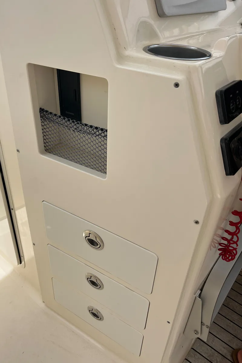 Slide: The Image of 2015 Scout 275 Dorado boat ladder compartment with stainless steel hardware. - 23