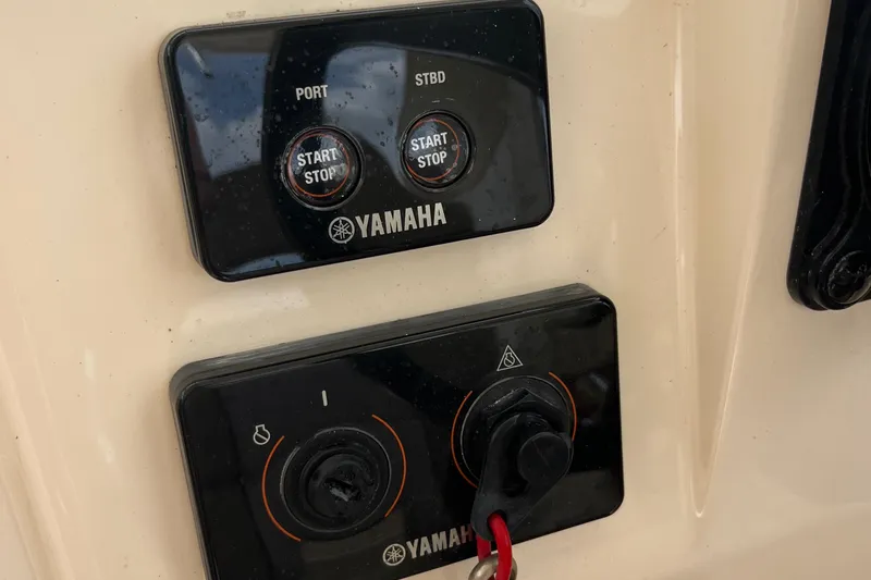 Slide: The Image of 2015 Scout 275 Dorado boat interior with twin 200 engines, beige seating. - 25