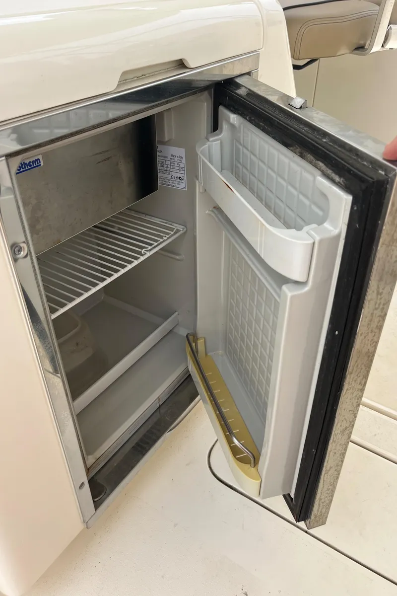 Slide: The Image of Interior view of 2015 Scout 275 Dorado boat with tan seating and stainless steel rail. - 27