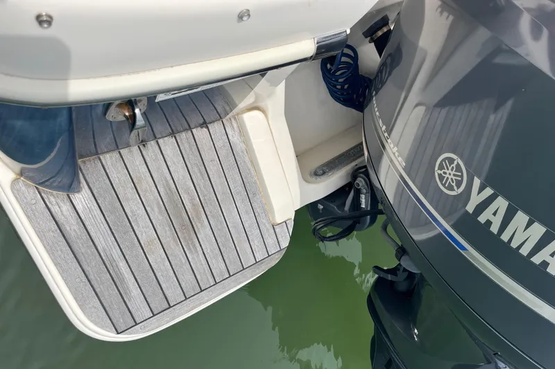 Slide: The Image of 2015 Scout 275 Dorado boat interior with tan seating and stainless steel rail. - 28