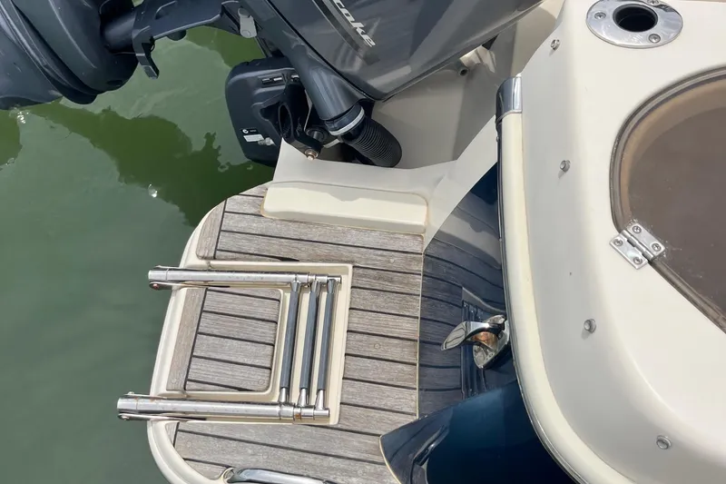 Slide: The Image of Interior view of 2015 Scout 275 Dorado boat with beige seating and speaker. - 29